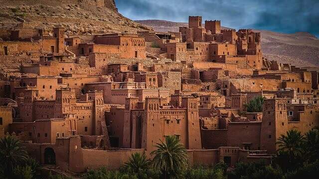 Historic Moroccan kasbah in Aït Benhaddou under dramatic sky – symbolizing Morocco’s role in Canada’s digital visa pilot program.