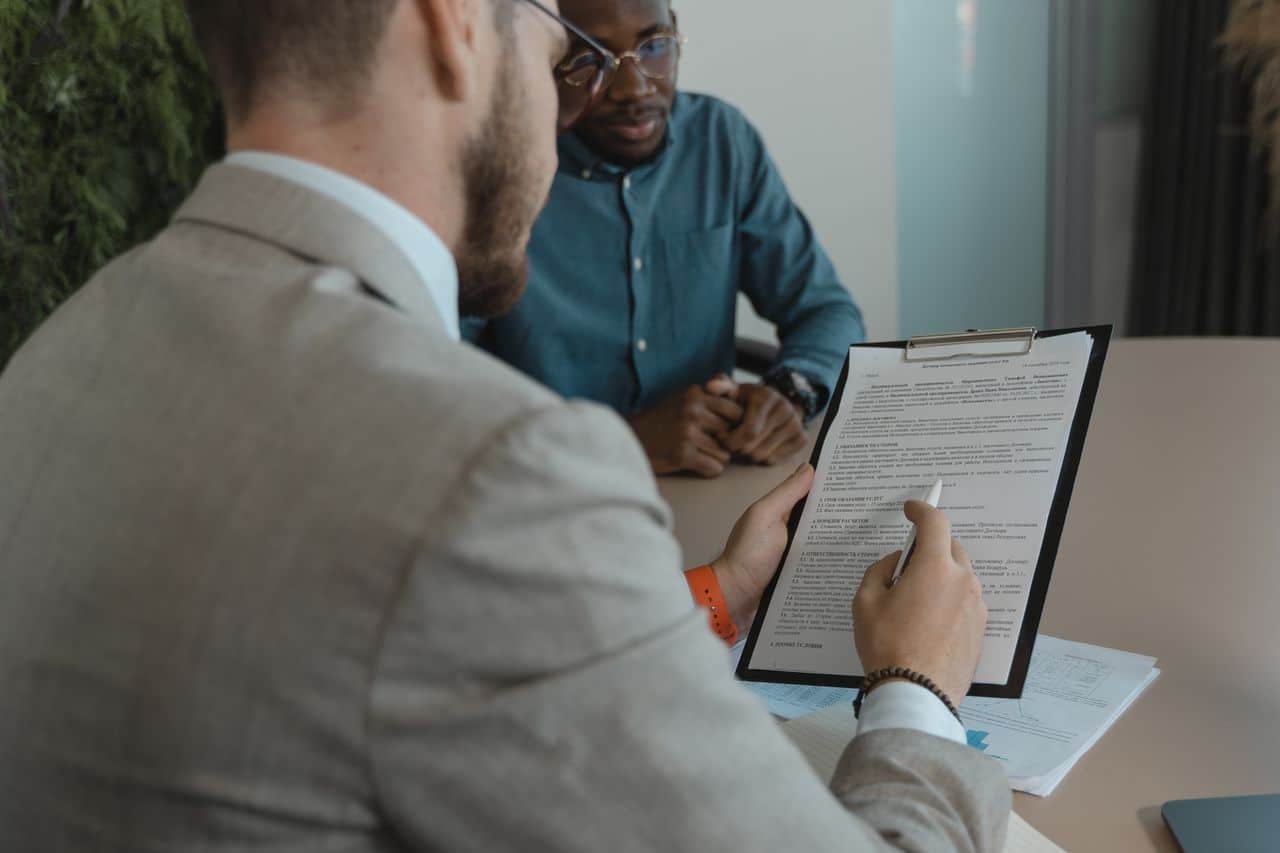 Canadian employer and prospective employee reviewing a job offer for a work permit application to comply with IRCC’s New Job-Offer Genuineness Rules.